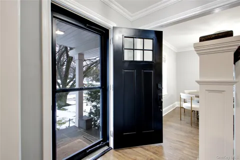 a view of a hallway view with wooden floor and staircase