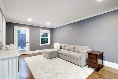 a living room with furniture and a dresser