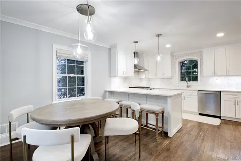 a kitchen with a table chairs sink and cabinets