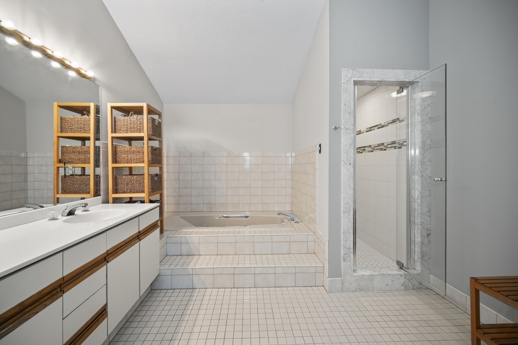 40 Millpond Road Sudbury, MA 01776 - Photo 29 of 40 a bathroom with a granite countertop sink a toilet and shower