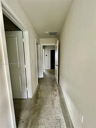 a view of a hallway with a wooden door