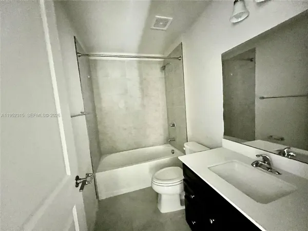 a bathroom with a sink toilet tub and shower