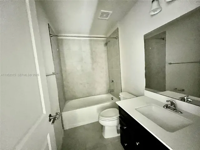 a bathroom with a sink toilet tub and shower