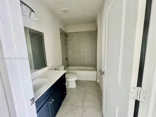 a bathroom with a tub sink toilet and a mirror