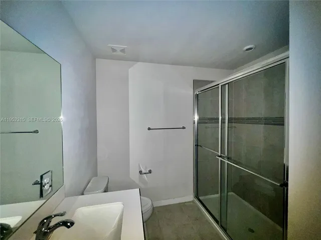 a bathroom with a shower and a sink