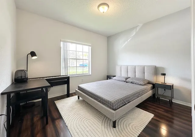 a bedroom with a bed and a desk