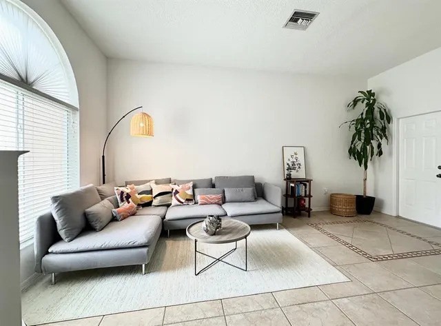a living room with furniture and a potted plant