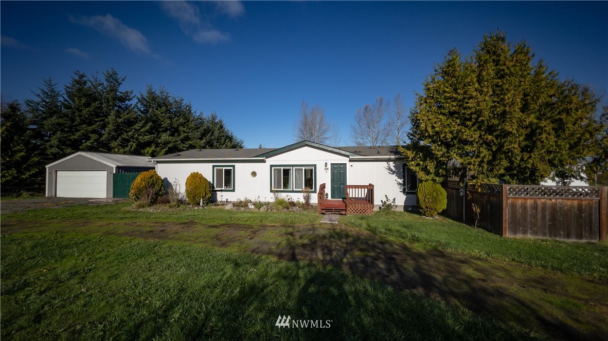 291 Spencer Road Sequim, WA 98382 - Photo 1 of 24 a front view of a house with a yard