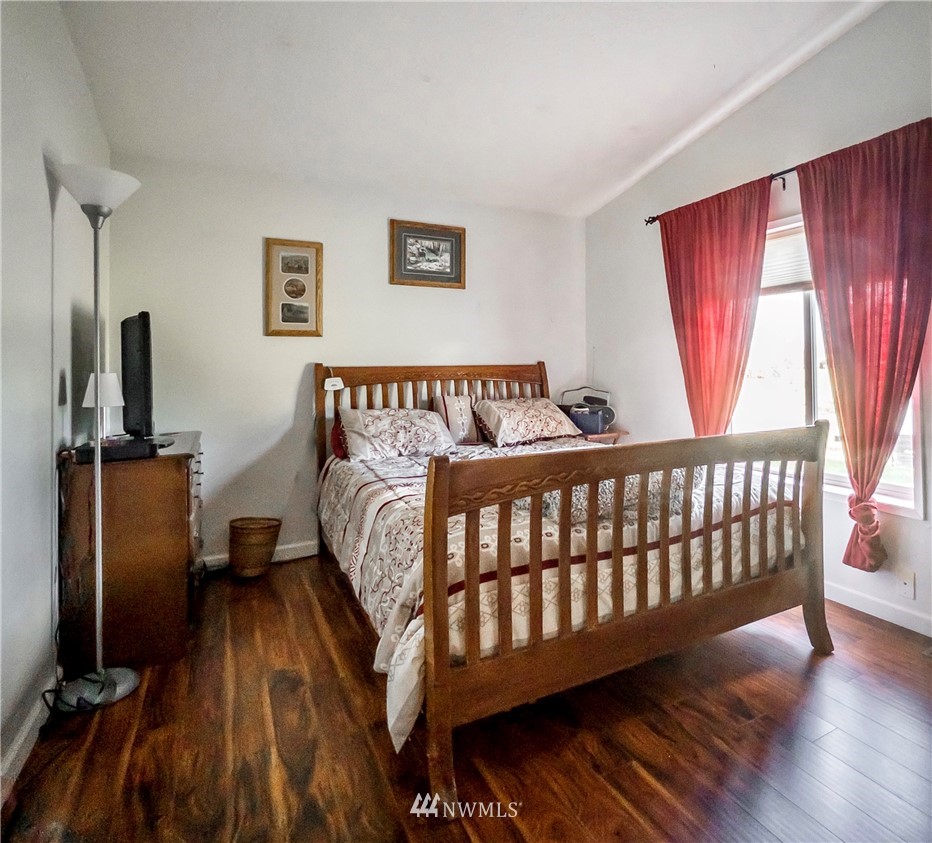 291 Spencer Road Sequim, WA 98382 - Photo 14 of 24 a bedroom with a bed and wooden floor