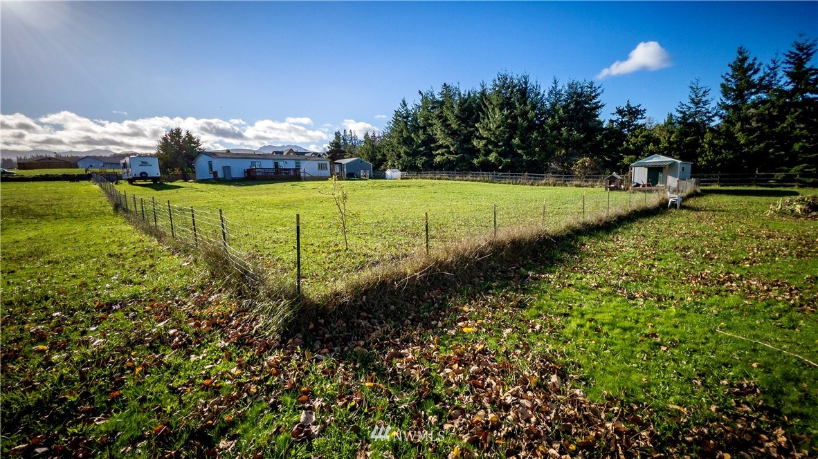 291 Spencer Road Sequim, WA 98382 - Photo 19 of 24 a view of a lake with houses