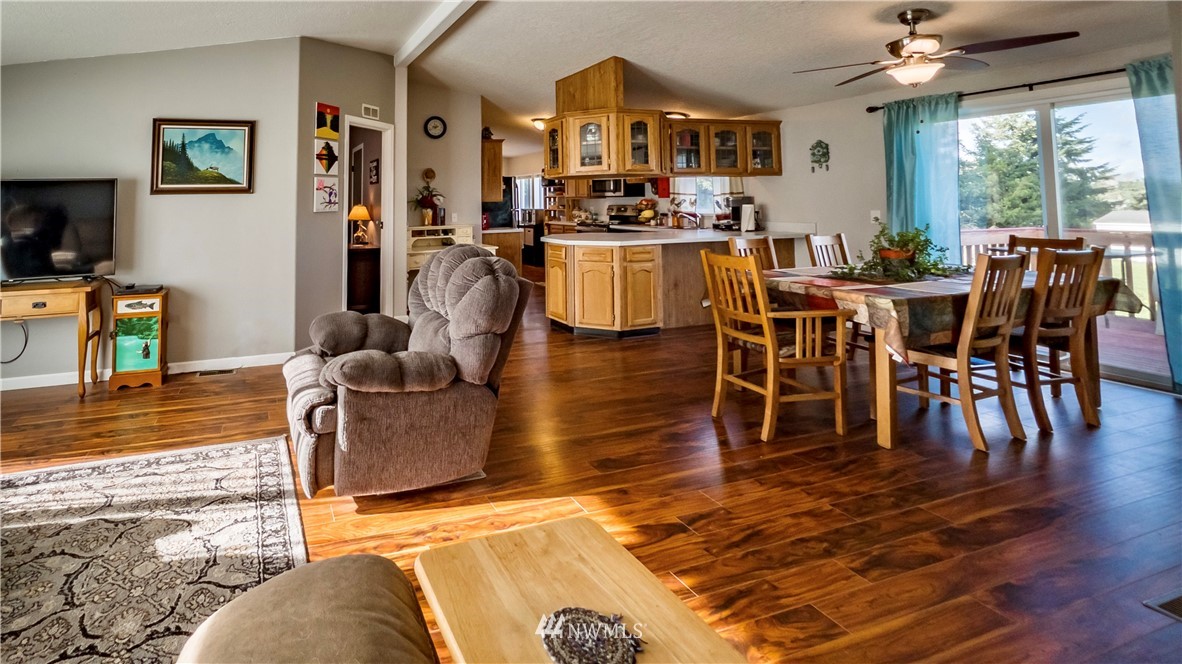 291 Spencer Road Sequim, WA 98382 - Photo 5 of 24 a view of a dining room with furniture window and wooden floor