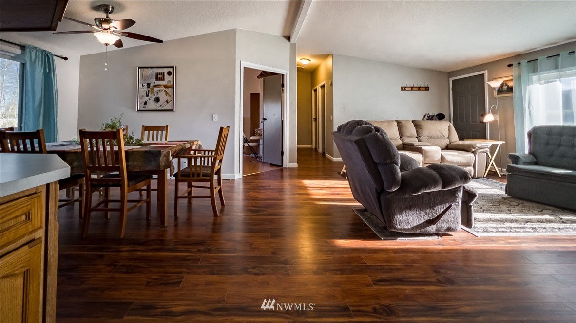 291 Spencer Road Sequim, WA 98382 - Photo 6 of 24 a view of a dining room with furniture window and wooden floor