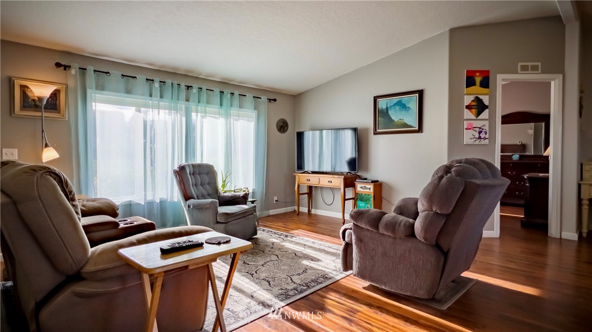 291 Spencer Road Sequim, WA 98382 - Photo 7 of 24 a living room with furniture a desk and chair with wooden floor