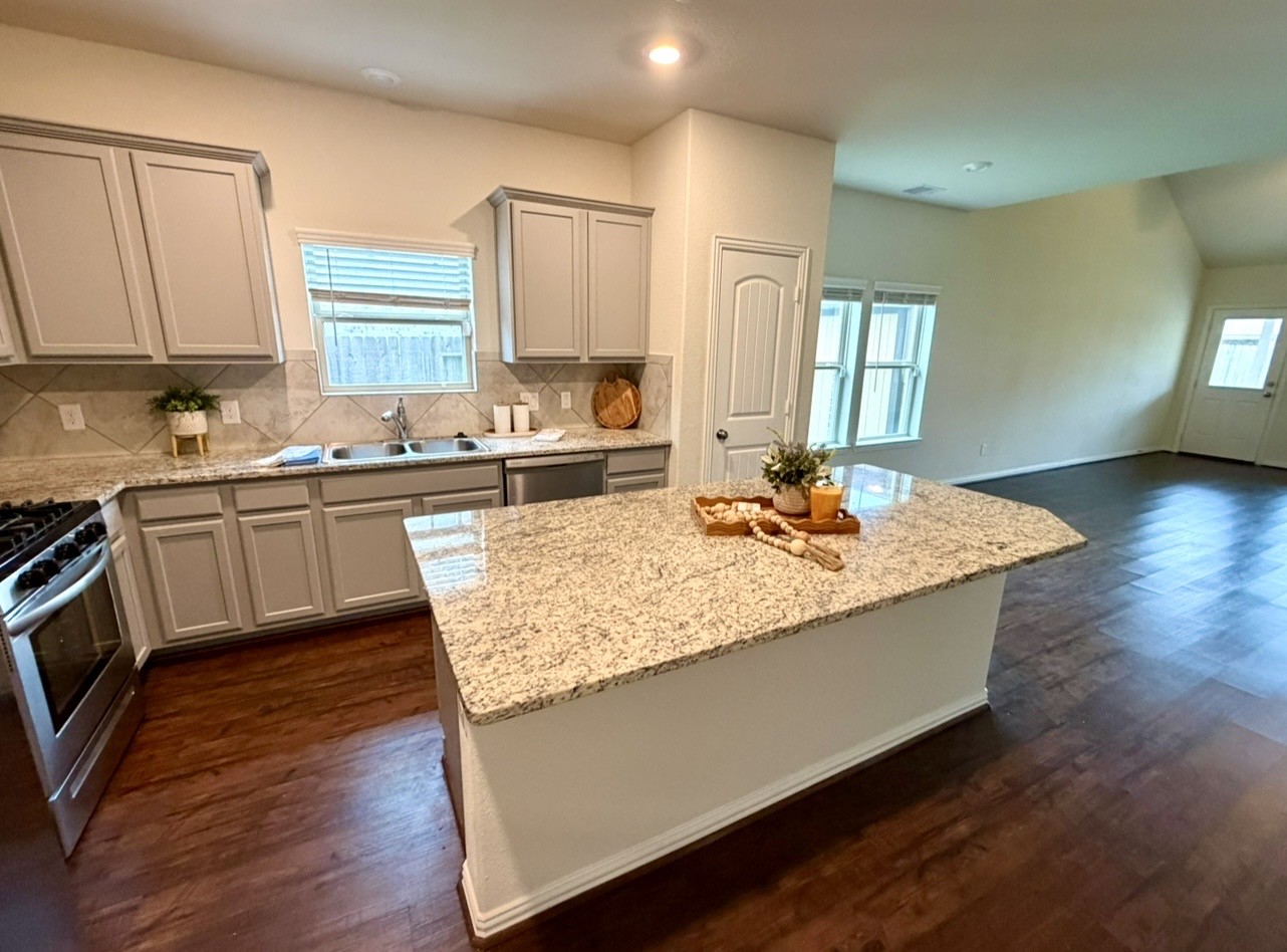 4706 Walnut Willow Ct Spring Spring, TX 77386 - Photo 12 of 17 a kitchen with granite countertop a sink cabinets and wooden floor