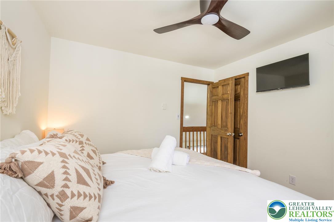 2206 Chatham Court Bushkill, PA 18324 - Photo 12 of 45 a bedroom with a large bed and a tv