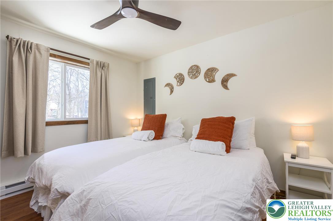 2206 Chatham Court Bushkill, PA 18324 - Photo 15 of 45 a bedroom with a bed and a chandelier