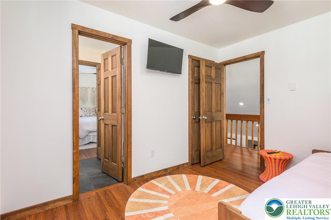 2206 Chatham Court Bushkill, PA 18324 - Photo 19 of 45 a bedroom with a bed and wooden floor