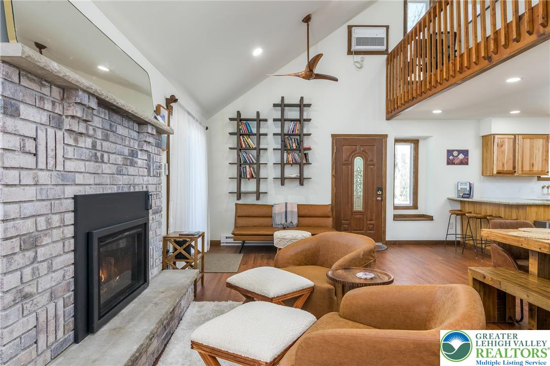 2206 Chatham Court Bushkill, PA 18324 - Photo 23 of 45 a living room with furniture and a fireplace
