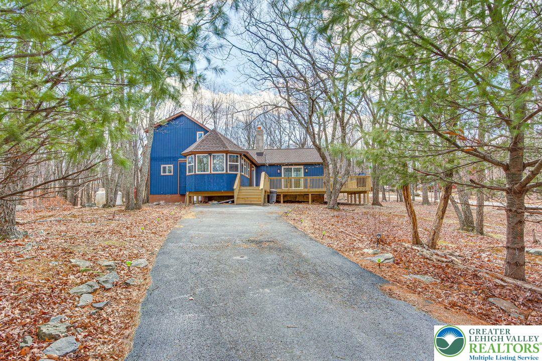 2206 Chatham Court Bushkill, PA 18324 - Photo 26 of 45 a front view of a house with a yard and large trees