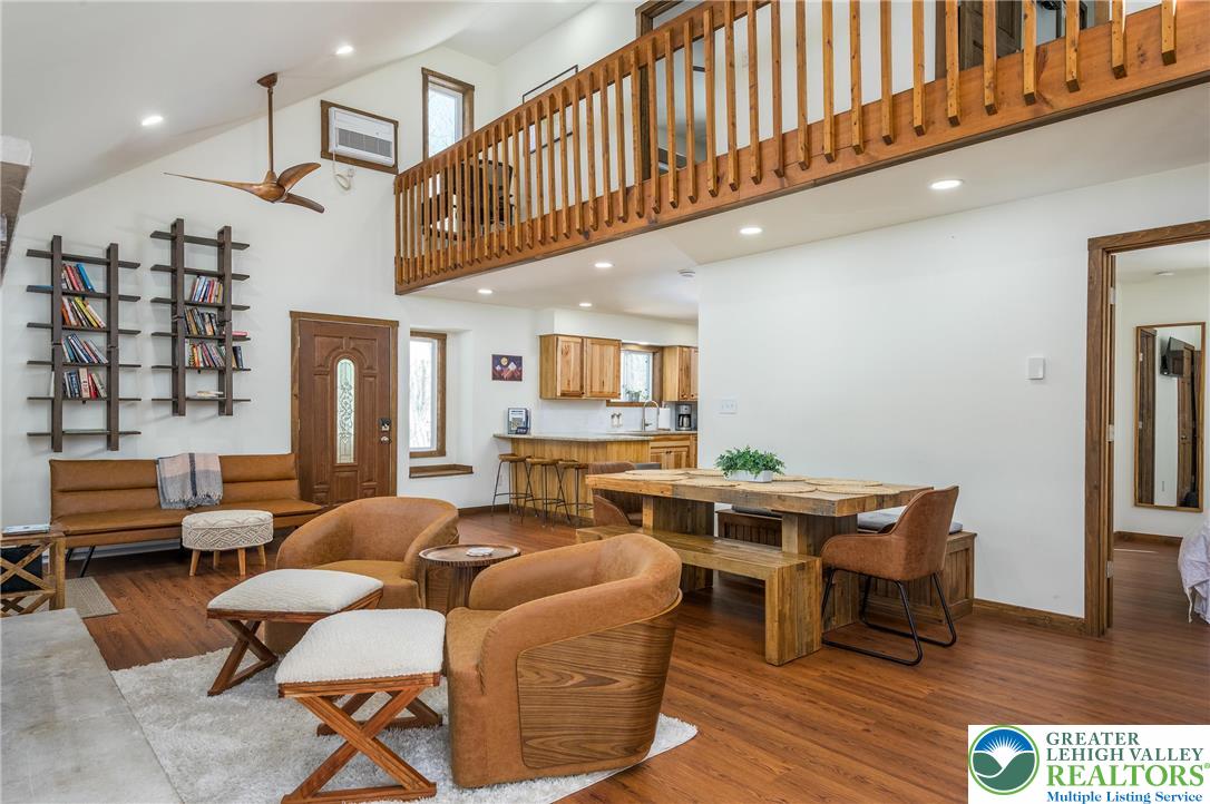 2206 Chatham Court Bushkill, PA 18324 - Photo 3 of 45 a living room with furniture a flat screen tv and kitchen floor