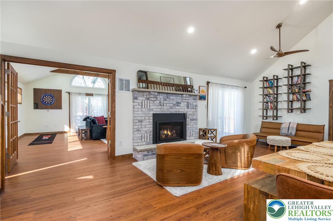 2206 Chatham Court Bushkill, PA 18324 - Photo 8 of 45 a living room with furniture large window and a fireplace