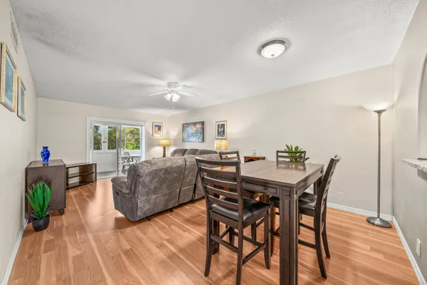 a view of a dining room with furniture and wooden floor