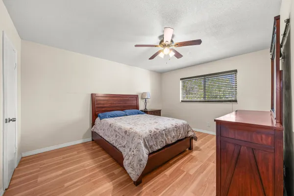 a bedroom with a large bed and a chandelier