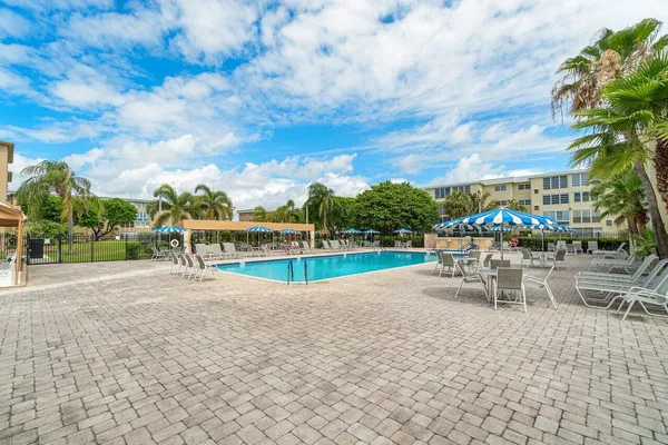 an outdoor space with swimming pool and furniture
