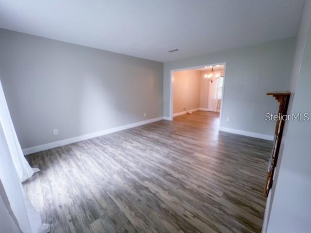 1928 Lawson Road Tallahassee, FL 32308 - Photo 2 of 20 a view of an empty room with wooden floor and a window