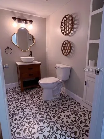 a bathroom with a toilet a sink and a mirror