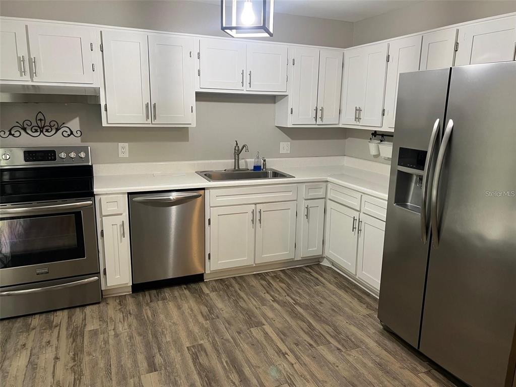 1928 Lawson Road Tallahassee, FL 32308 - Photo 6 of 20 a kitchen with stainless steel appliances a refrigerator sink and cabinets