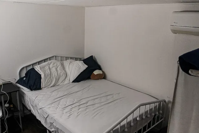 a bedroom with a bed and a window