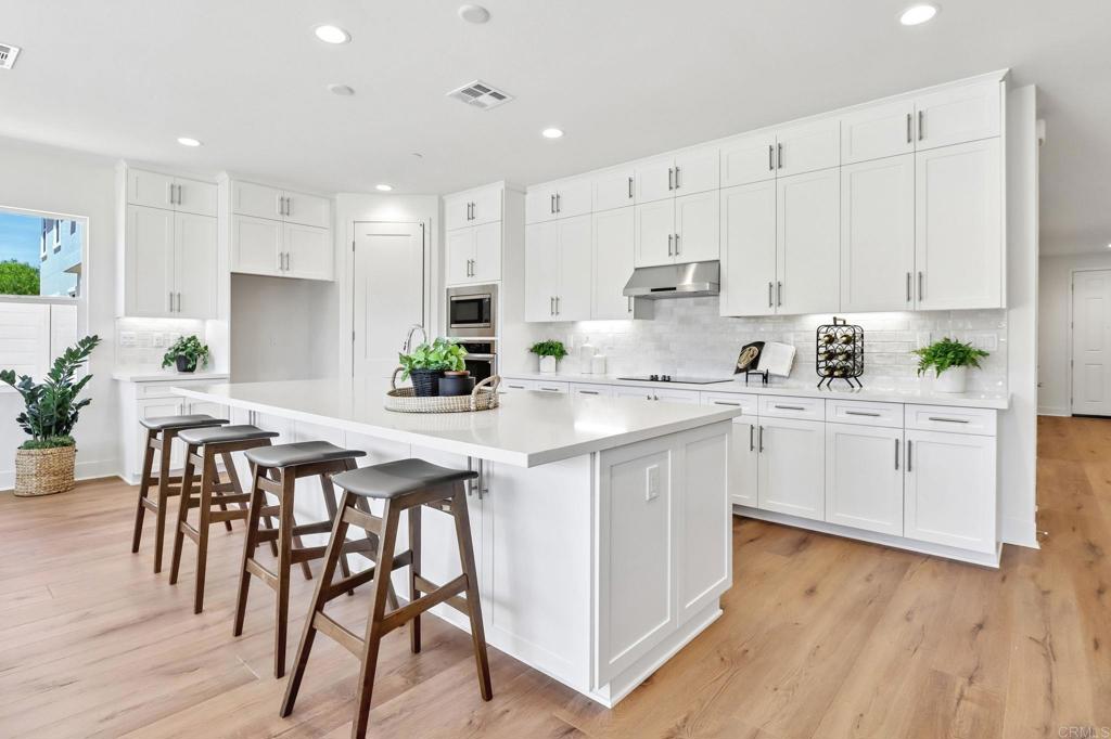 3521 Butler Place Escondido, CA 92027 - Photo 17 of 50 a kitchen with white cabinets stainless steel appliances and white cabinets