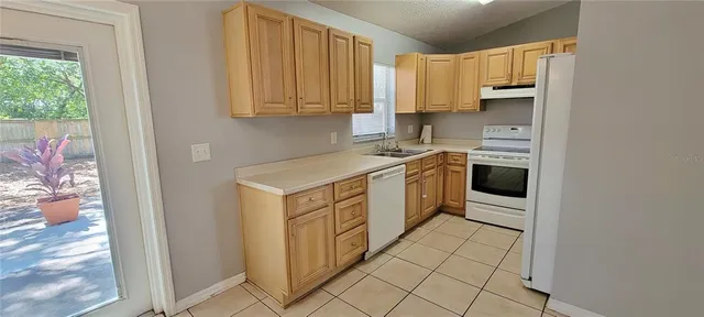 a kitchen with a sink cabinets and window