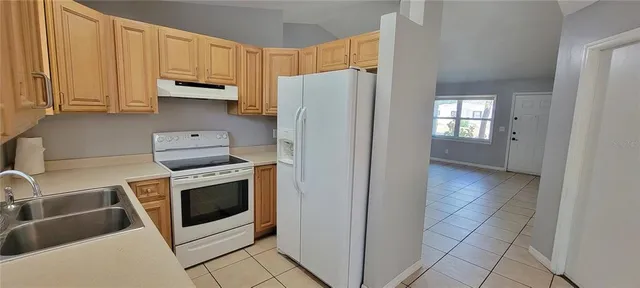 a kitchen with stainless steel appliances a stove a microwave and a white cabinets