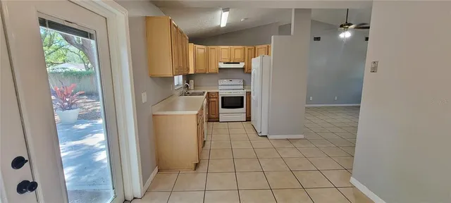 a kitchen with granite countertop a refrigerator and a stove