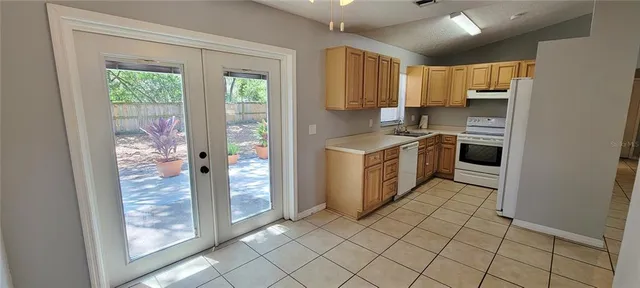 a kitchen with stainless steel appliances granite countertop a refrigerator and a sink