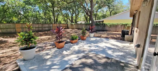 a view of a backyard with sitting area