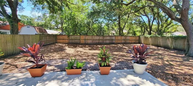 a view of a balcony with chairs and plants