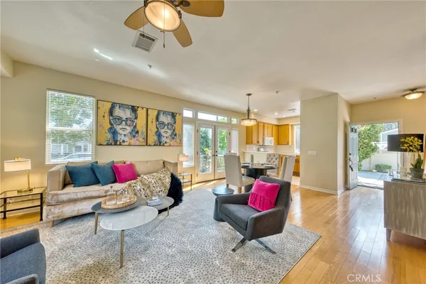 a living room with furniture and floor to ceiling windows
