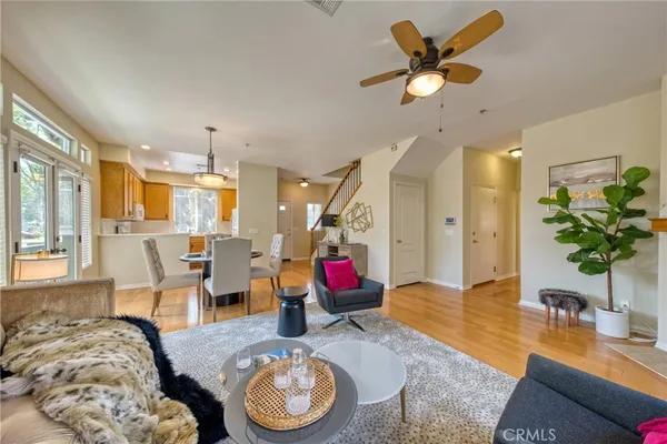 a living room with furniture and a chandelier