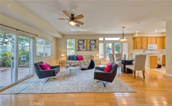 a living room with lots of furniture and kitchen view
