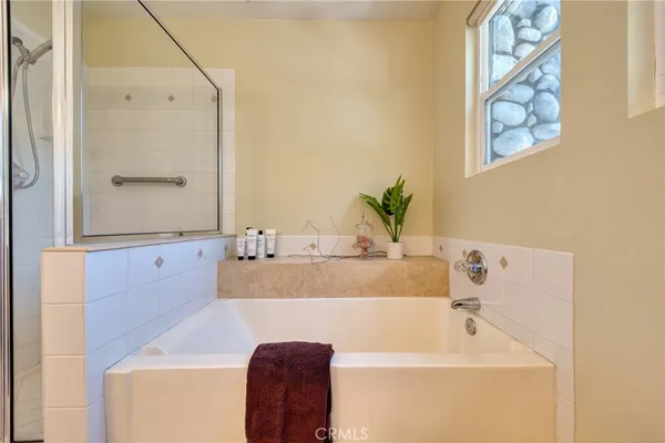 a bathroom with a tub sink and mirror