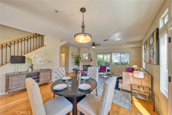 a dining room with furniture a chandelier and wooden floor
