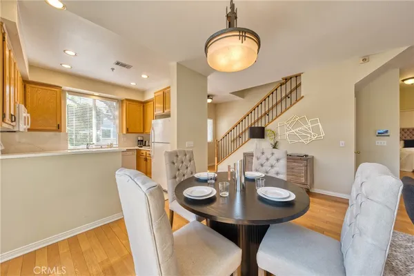 a view of a dining room with furniture and wooden floor