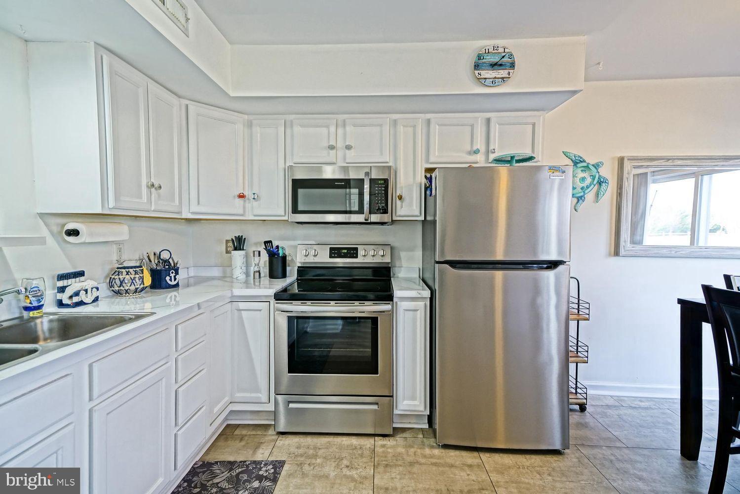 34531 Oakley Court, Unit 27 Lewes, DE 19958 - Photo 15 of 25 a kitchen with cabinets stainless steel appliances and a window
