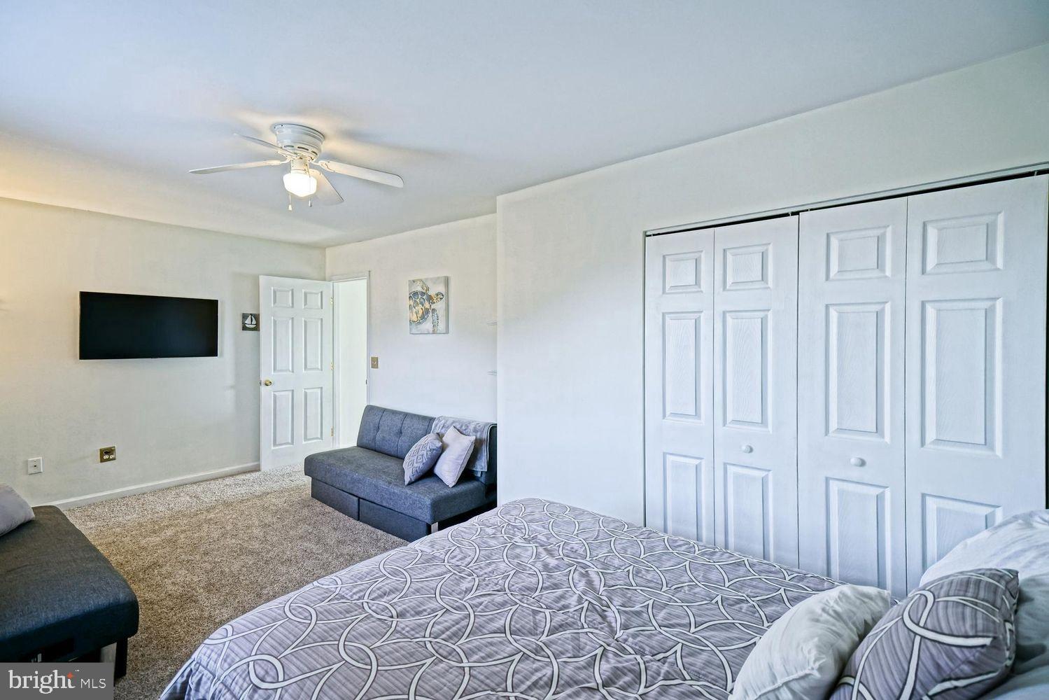 34531 Oakley Court, Unit 27 Lewes, DE 19958 - Photo 19 of 25 a bedroom with a bed and a couch