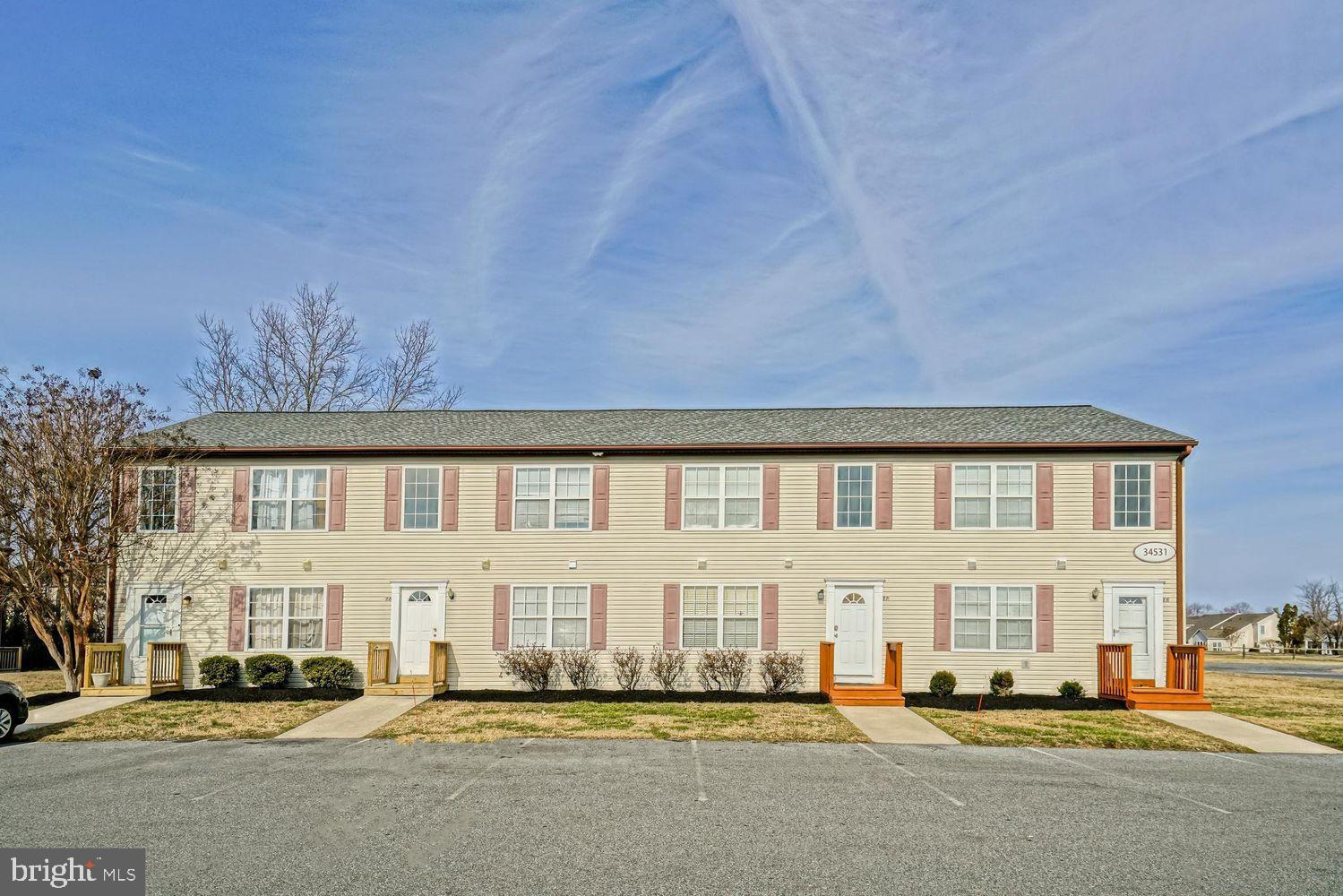 34531 Oakley Court, Unit 27 Lewes, DE 19958 - Photo 2 of 25 a front view of building with street