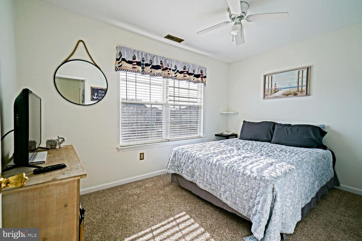 34531 Oakley Court, Unit 27 Lewes, DE 19958 - Photo 21 of 25 a bedroom with bed and a window
