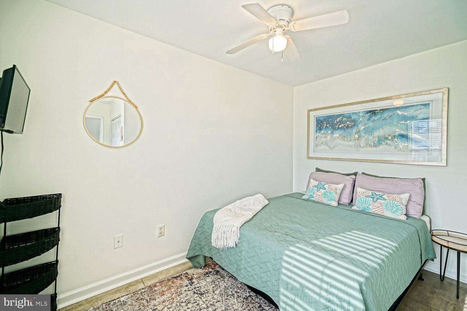 34531 Oakley Court, Unit 27 Lewes, DE 19958 - Photo 4 of 25 a bedroom with a bed and cabinets